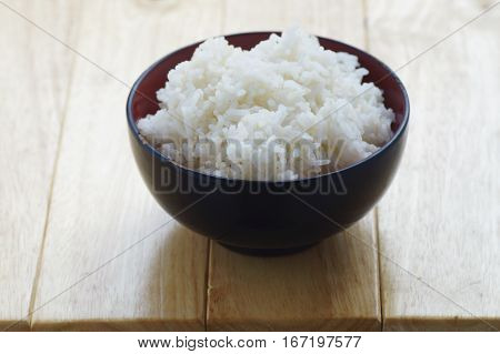 steam rice in bowl on wood table