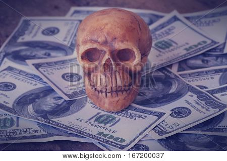 skull on bank note and coin money concept in work for money and death because of money