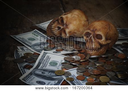 skull on bank note and coin money concept in work for money and death because of money