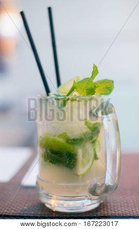 Mojito cocktail with lime and mint on a table