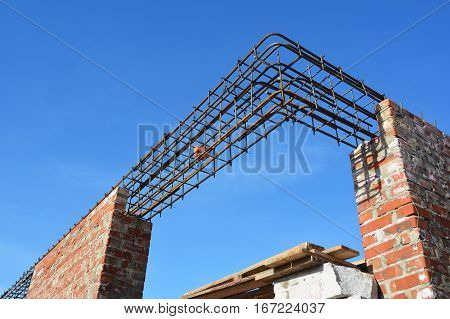 Rebar steel bars on new home construction corner reinforcement concrete bars with wire rod as a lintel for window.