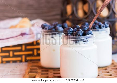 Homemade yogurt with blueberries in a glass jar