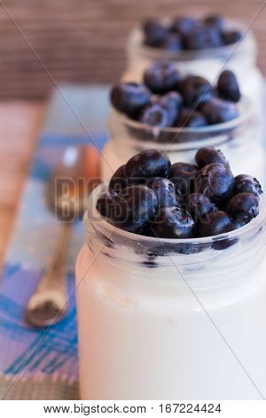 Homemade yogurt with blueberries in a glass jar