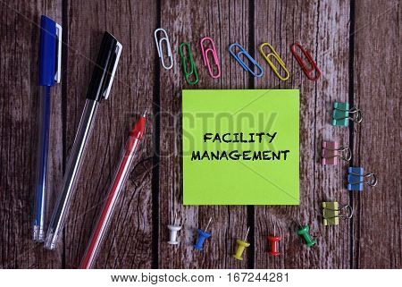 Tolls With Notes FACILITY MANAGEMENT Conceptual On Wooden Background