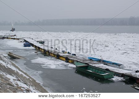 Frozen River With Accumulated Drift Ice Putting Preasure On Docks And Boats