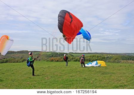 Paragliders launching their wings for take off
