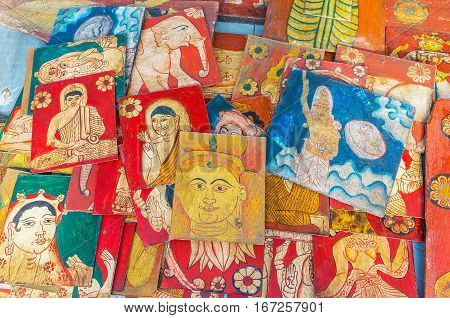 The small wooden boards covered with vintage paintings of Buddha Hindu Gods floral ornaments and animals are the perfect souvenirs from Galle Fair Sri Lanka.