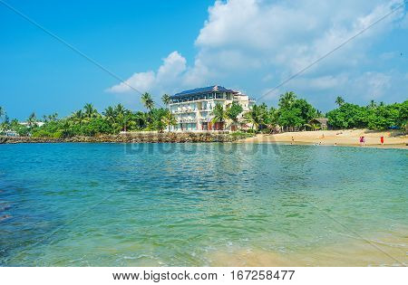 The modern hotel complex at the coast of Midigama next to the comfortable sand beach Sri Lanka.