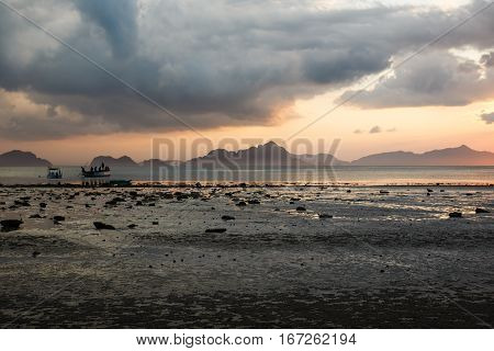 Boats and beach during the low tide on Philippines