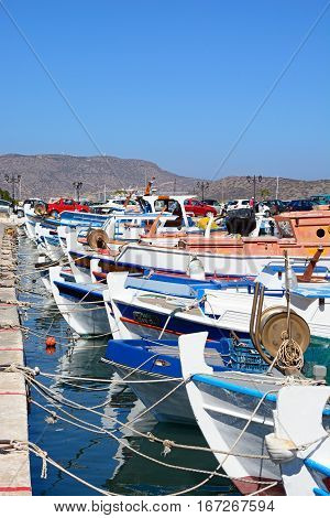 ELOUNDA, CRETE - SEPTEMBER 17, 2016 - The fronts of a row of traditional fishing boats in the harbour Elounda Crete Greece Europe, September 17, 2016.
