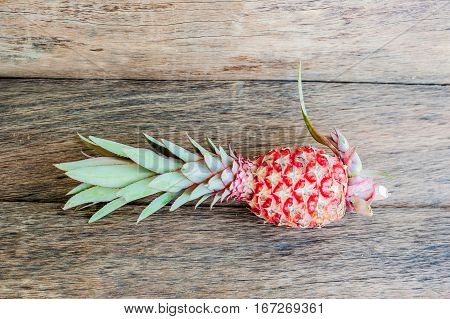 Organic Pink Pineapple On The Old Wooden Background