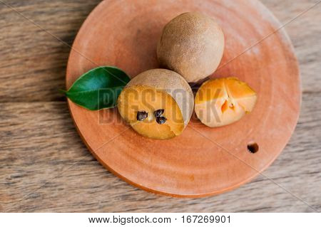 Fresh Sapodilla Fruits On Old Wooden Background