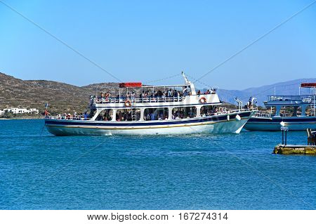 ELOUNDA, CRETE - SEPTEMBER 17, 2016 - Tourists on tour boats in the harbour Elounda Crete Greece Europe, September 17, 2016.
