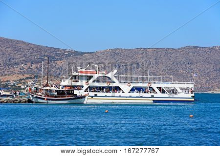 ELOUNDA, CRETE - SEPTEMBER 17, 2016 - Tourists on tour boats in the harbour Elounda Crete Greece Europe, September 17, 2016.