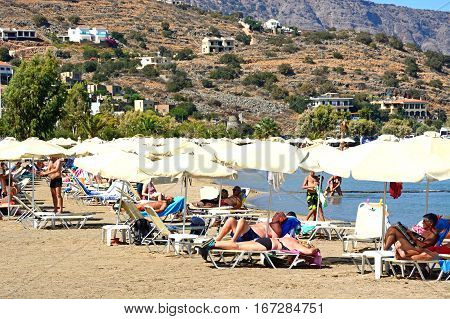ELOUNDA, CRETE - SEPTEMBER 17, 2016 - Tourists relaxing on the beach Elounda Crete Greece Europe, September 17, 2016.
