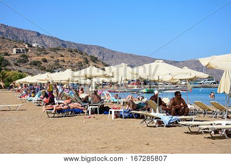 ELOUNDA, CRETE - SEPTEMBER 17, 2016 - Tourists relaxing on the beach Elounda Crete Greece Europe, September 17, 2016.