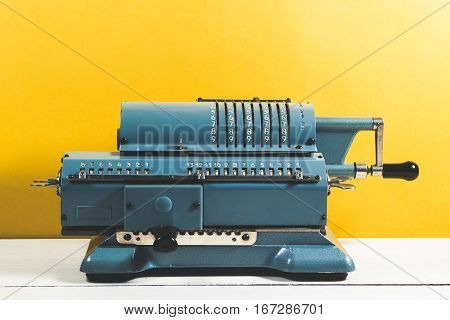 Old Calculating Machine On A Wooden Table