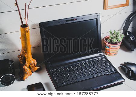 Laptop and gadgets on a white wooden table