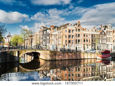 Old houses facades over canal with mirror reflections, Amstardam, Netherlands