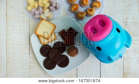 Pig is a symbol of obese people Many dessert on wooden