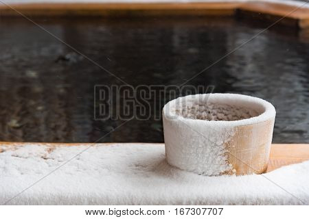Japan natural mineral hot spring called onsen cover by snow in Japanese ryokan on the moutain okuhida takayama japan.