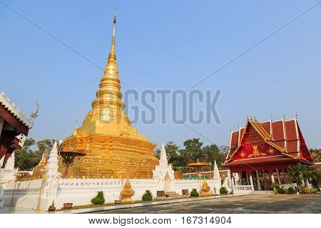 NAN THAILAND - 17 FEBRUARY 2015 - Golden pagoda named Phra That Chae Haeng and red gazebo in Nan province Thailand