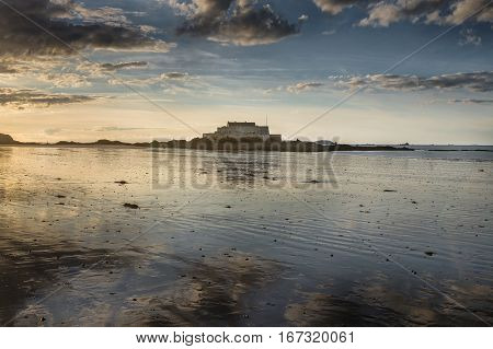 Island of fort national from the beach and sunset reflection Saint-Malot Bretagne France