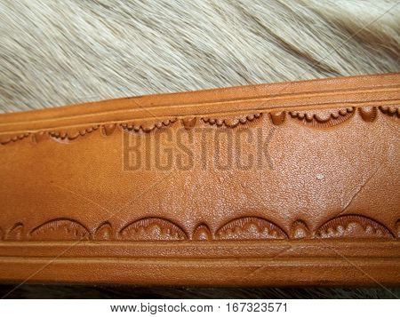 Leather belt displayed on a deer hide