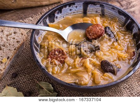 Christmas cabbage soup with mushrooms on natural background.