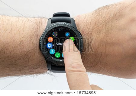 CHESTER UK - January 28 2017: Samsung Gear S3 smartwatch shown on a male wrist and operating the touch screen.