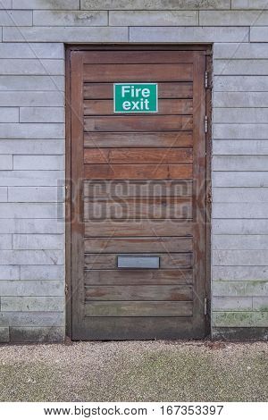 A wooden fire exit door in a modern apartment building