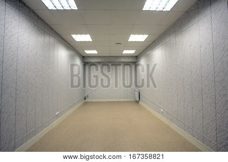 Small abandoned office space with no windows and unfurnished.