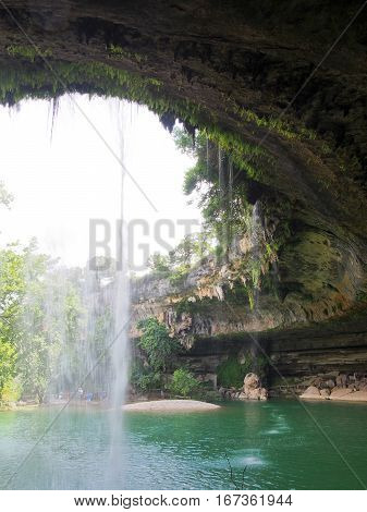 A waterfall at a limestone rock formation at Hamilton Pool Preserve near Austin Texas.