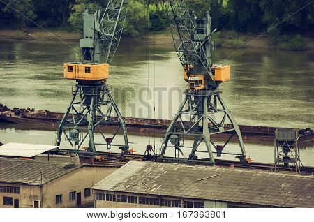Metals recycling on a river bank with freighter in a background