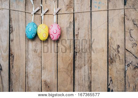 Easter Egg Hanging Clothseline On Wood Backhround With Space.