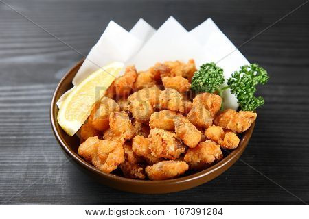 studio shot of fried chicken cartilage with lemon