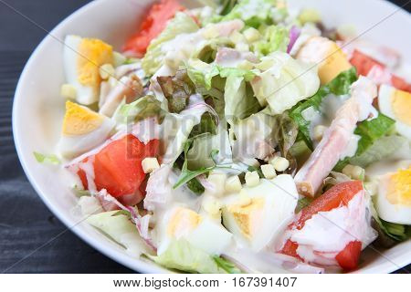 studio shot of fresh caeser salad with dressing