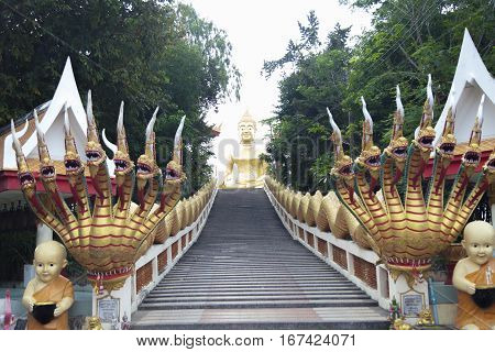 Big Gold Buddha sits and silently watches vanity below