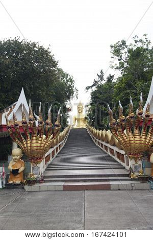 Big Gold Buddha sits and silently watches vanity below