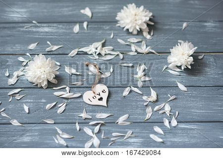 Happy Valentines Day background. Decorative white wooden hearts on grey rustic wooden background. Valentine's Day