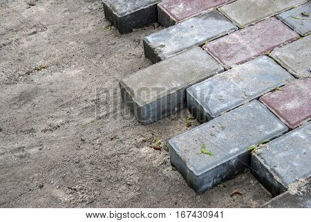 Installing paver bricks for the sidewalk pavement