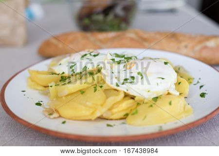 White Dish With Fried Potatoes And Eggs