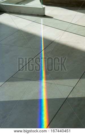 A glass spliting sunlight into spectrum colors