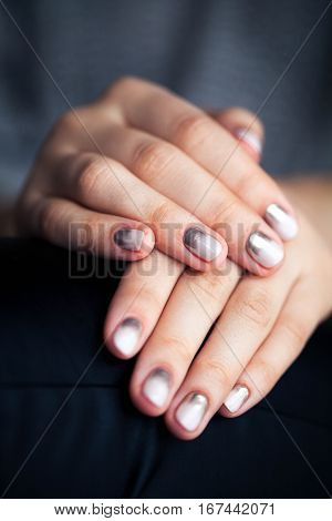 Stylish gray manicure with overflowing Fashion hands fingers