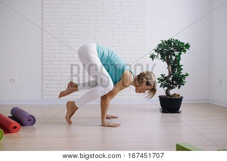 young girl in a blue t-shirt doing yoga at home. wellness concept