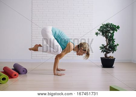 young girl in a blue t-shirt doing yoga at home. wellness concept