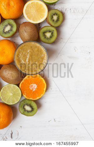 Smothie rich in vitamin C made with oranges, lemons, limes, clementines kiwis. top view. selective focus