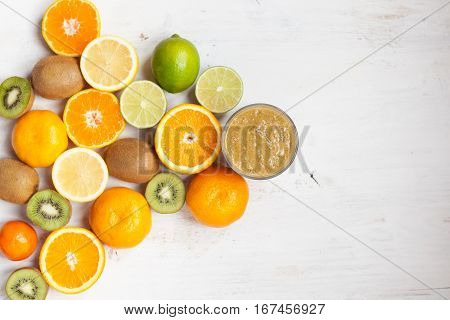 Smothie rich in vitamin C made with oranges, lemons limes clementines kiwis top view; selective focus