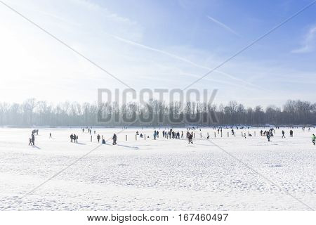 People on a frozen Lake
Kuhsee in Winter. 
Augsburg - Germany