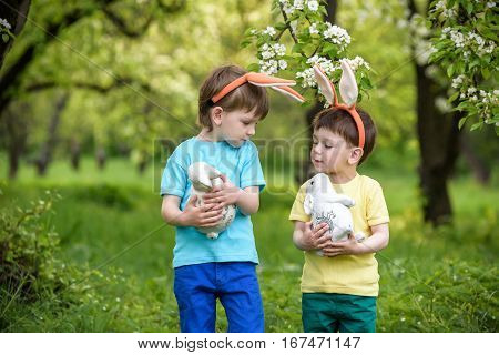 Two Little Kids Boys And Friends In Easter Bunny Ears During Tra